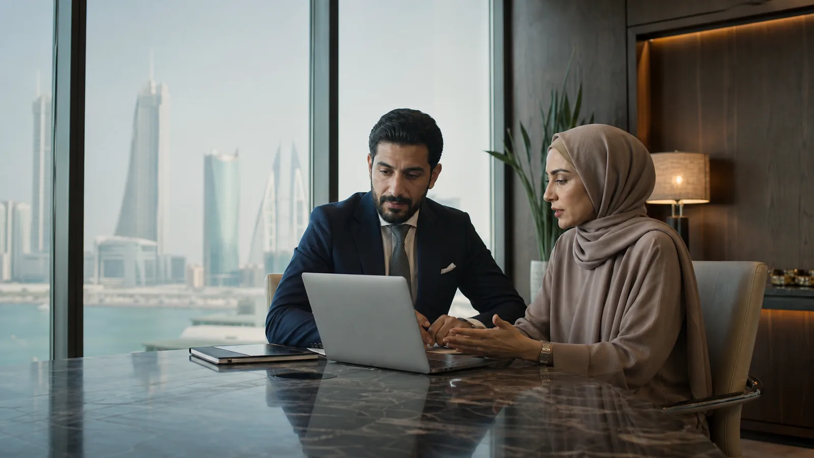 Bahrain finance professionals reviewing a digital product in Manama